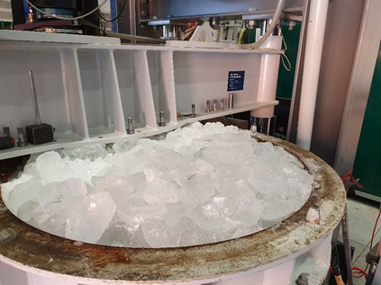 A sample of brash ice in a container of a cold climate laboratory